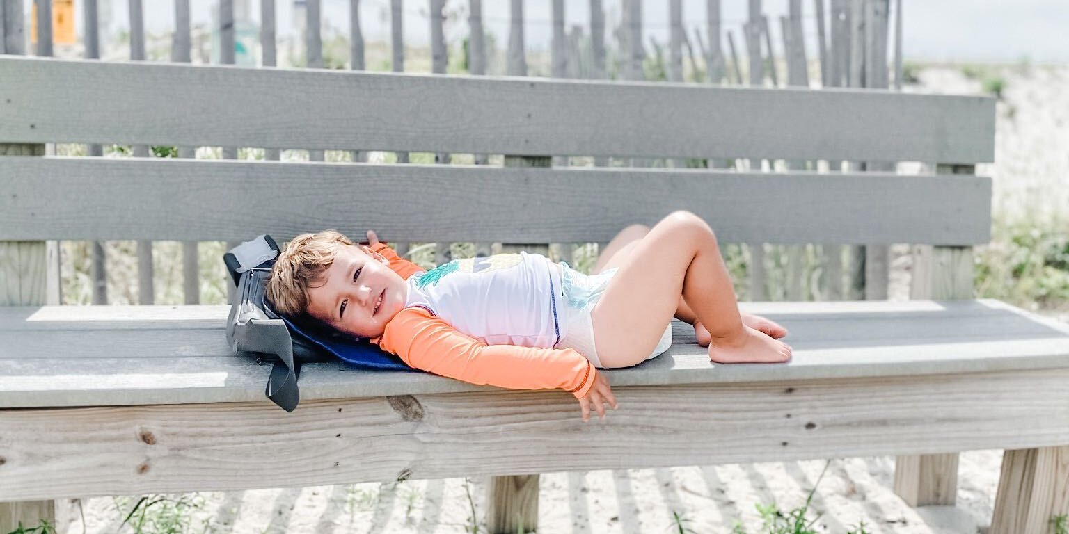 Toddler on diaper changing pad at the beach