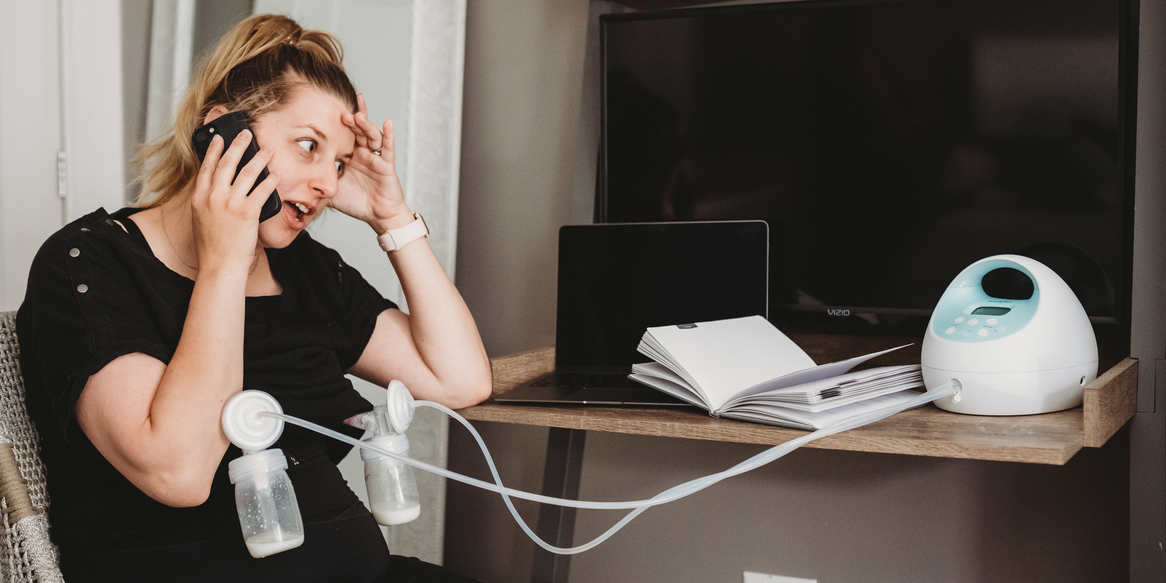 Woman back to work after maternity leave stressed out and trying to pump while on a work call